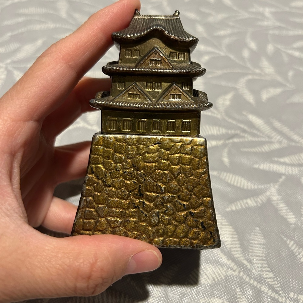 vintage Japanese metal incense burner shaped like a three-tiered pagoda.